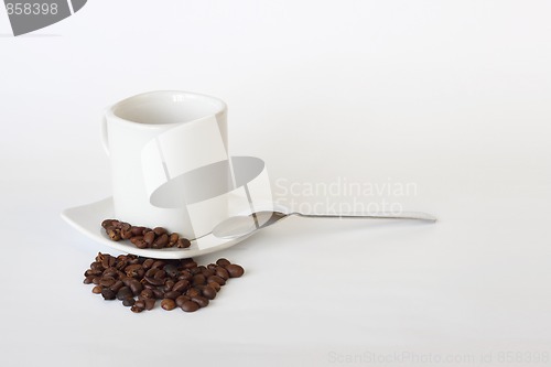 Image of coffee mug spoon spilled coffee on white 