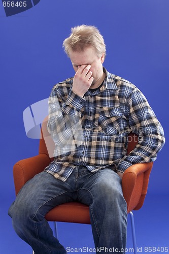 Image of Tired Man Sitting On A Chair