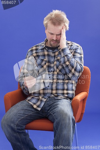 Image of Tired Man Sitting On A Chair