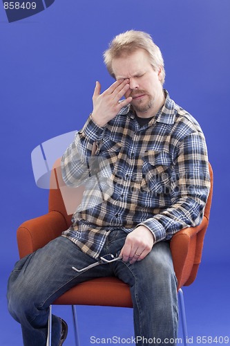 Image of Tired Man Sitting On A Chair