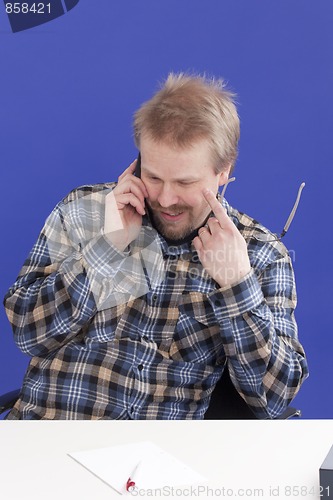 Image of Man Takes A Personal Phone Call