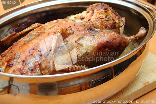 Image of Roasted duck in pan on the wooden desk
