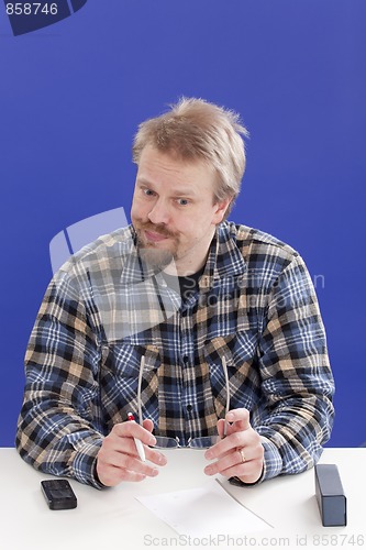 Image of Displeased Business Manager At His Office Desk