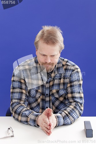 Image of Displeased Business Manager At His Office Desk