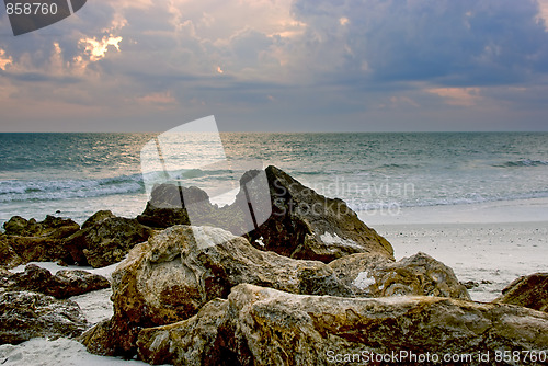 Image of rocks on the beach at sunset