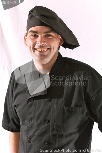 Image of smiling chef in black uniform