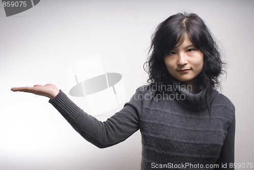 Image of Young woman showing hand