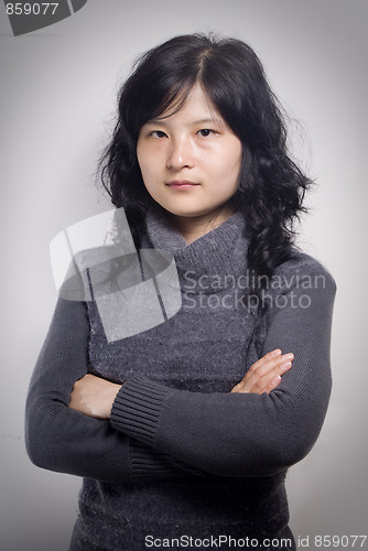 Image of Attractive businesswoman with her arms crossed