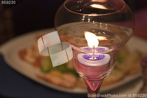 Image of Lighted Candle over a Table