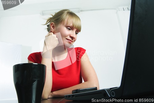 Image of Woman in red looking to monitor