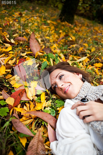 Image of Happy beautiful autumn woman