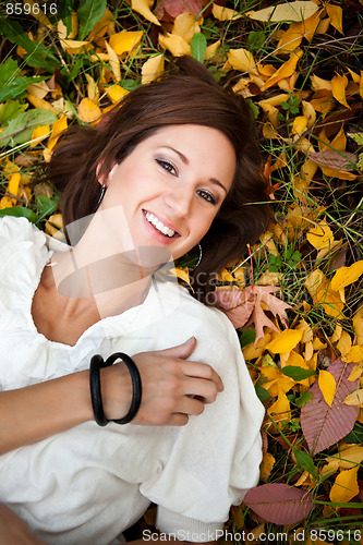 Image of Happy beautiful autumn woman
