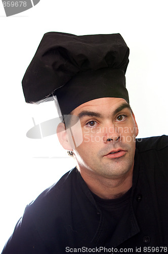 Image of male chef in black hat and coat