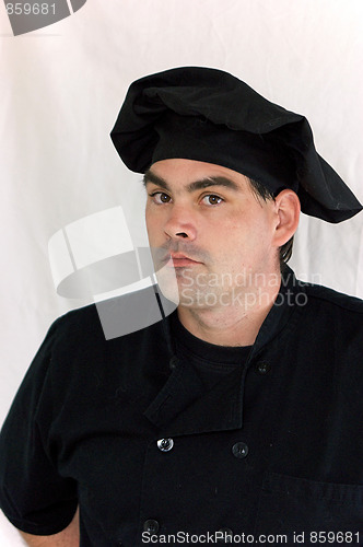 Image of serious chef dressed in black