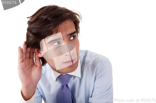 Image of Young businessman, listening, viewing the  gesture of hand behind ear