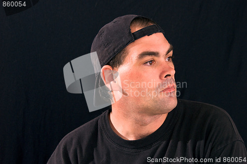 Image of profile portrait of man in street clothes