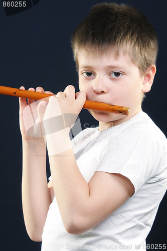 Image of Boy in white playing flute