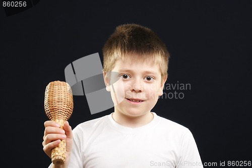 Image of Boy in white playing maracas