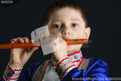 Image of Little boy playing flute