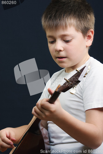 Image of Boy in white playing balalaika