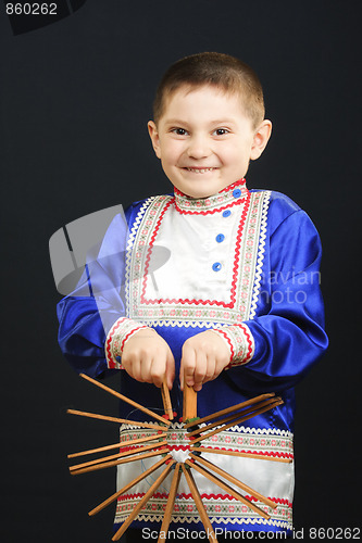 Image of Little boy playing clapper