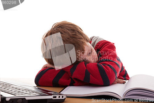 Image of cute boy on the desk asleep while studying