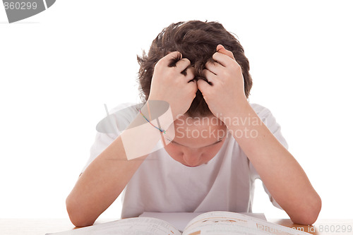 Image of cute boy on the desk studying and despairing