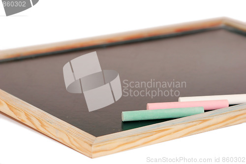 Image of stick of color chalk on a blackboard isolated background