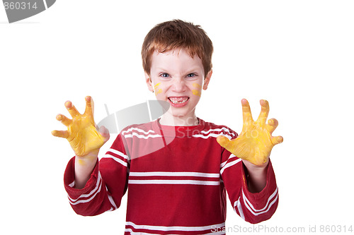 Image of Happy Kid playing with yellow paint