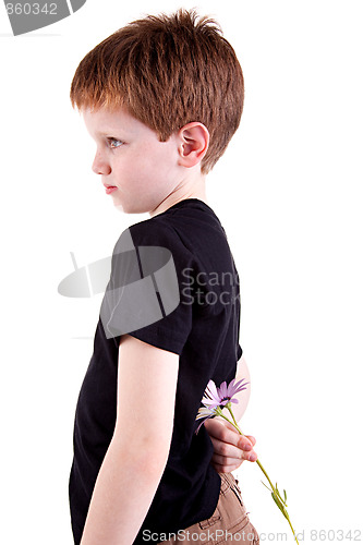 Image of Young boy hiding flowers behind his back