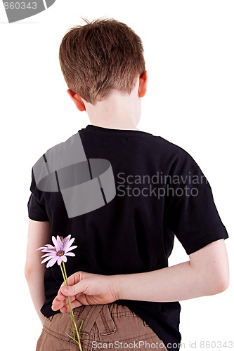 Image of Young boy hiding flowers behind his back