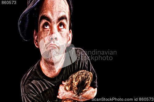 Image of distorted man with crazed look holding cat