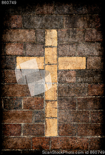 Image of christian cross in brick wall