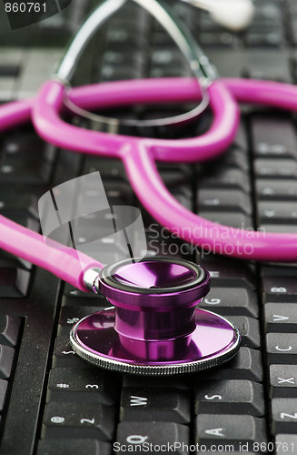 Image of pink stethoscope on keyboard