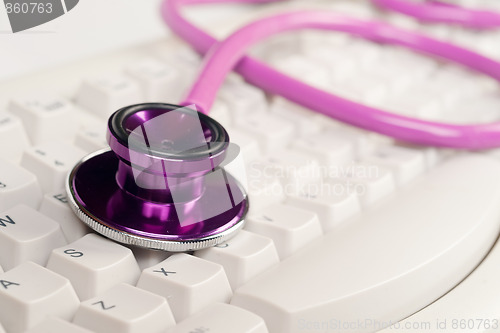 Image of pink stethoscope on white keyboard