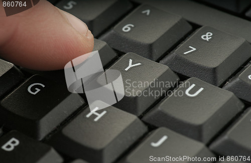 Image of finger pressing keyboard
