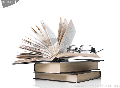 Image of pile of books and eyeglasses