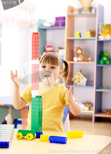 Image of Little girl play with building bricks in preschool