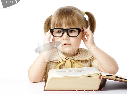 Image of Cute little girl with book, back to school