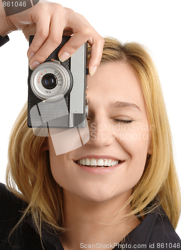 Image of young woman taking a shot with photo camera