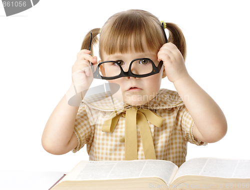 Image of Cute little girl with book wearing black glasses