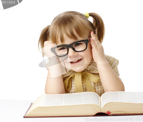 Image of Happy little girl with book wearing black glasses