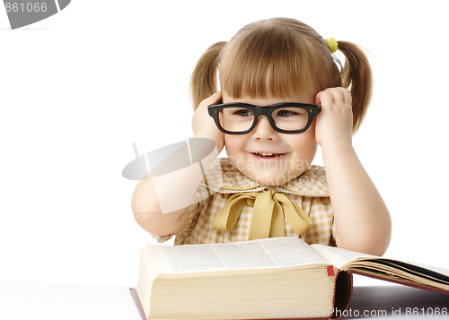 Image of Happy little girl with book wearing black glasses