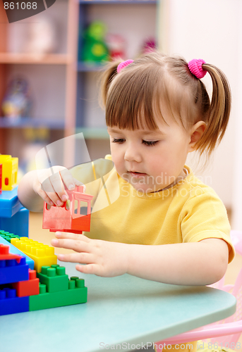 Image of Little girl play with building bricks in preschool