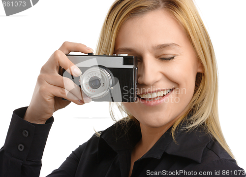 Image of young woman taking a shot with photo camera