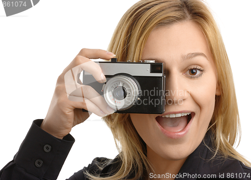 Image of young woman taking a shot with photo camera