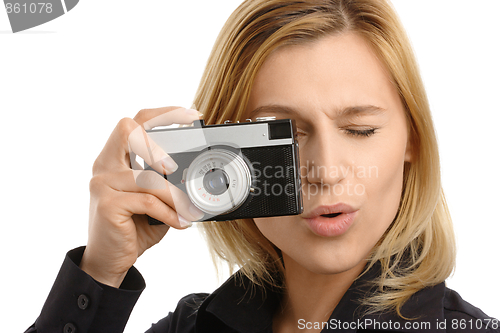 Image of young woman taking a shot with photo camera