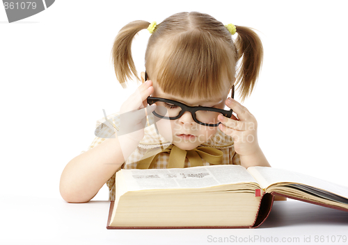 Image of Cute little girl reading book, back to school