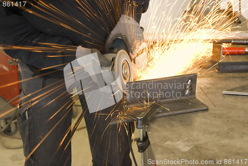 Image of steel worker grinder