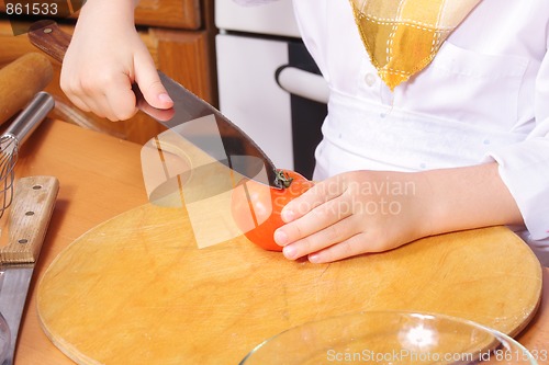 Image of Cook hands handles tomato